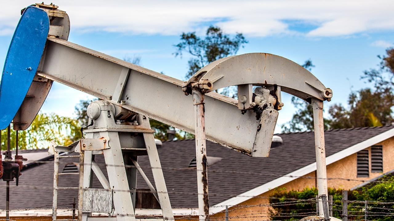 Historically Redlined Neighborhoods Burdened by Excess Oil and Gas Wells
